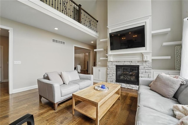 8833 N Crescent Ave, Kansas City, MO 64157 - living area featuring a fireplace, wood finished floors, a towering ceiling, recessed lighting, and baseboards