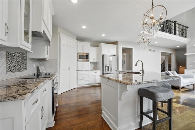 8833 N Crescent Ave, Kansas City, MO 64157 - kitchen with appliances with stainless steel finishes, a sink, white cabinetry, custom exhaust hood, and glass insert cabinets