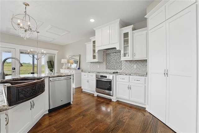 8833 N Crescent Ave, Kansas City, MO 64157 - kitchen featuring stainless steel appliances, a sink, decorative backsplash, light stone counters, and recessed lighting