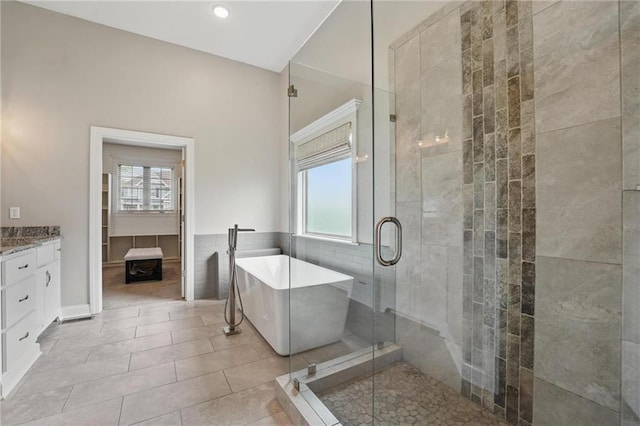 8833 N Crescent Ave, Kansas City, MO 64157 - full bathroom featuring a soaking tub, vanity, a stall shower, and tile patterned floors
