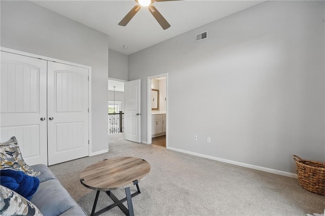 8833 N Crescent Ave, Kansas City, MO 64157 - carpeted living room featuring a ceiling fan, baseboards, and a towering ceiling