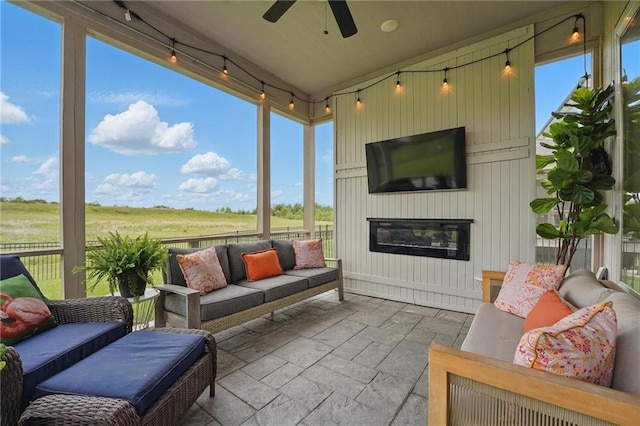 8833 N Crescent Ave, Kansas City, MO 64157 - sunroom with an outdoor living space with a fireplace, ceiling fan, and rail lighting