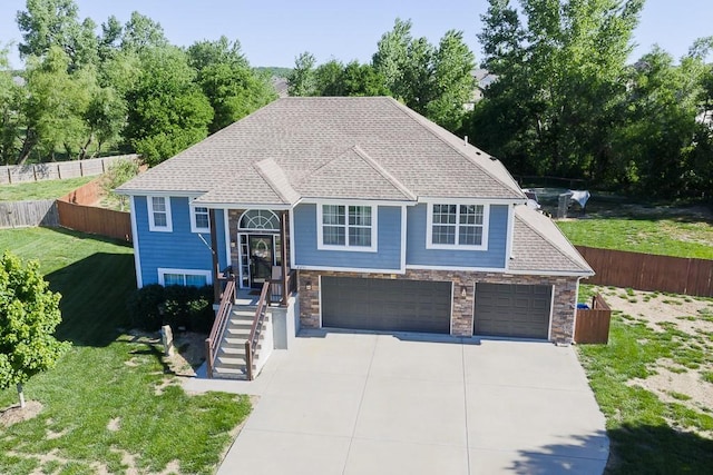 2251 Valley View Dr, Tonganoxie, KS 66086 - bi-level home featuring stairs, stone siding, driveway, and a shingled roof