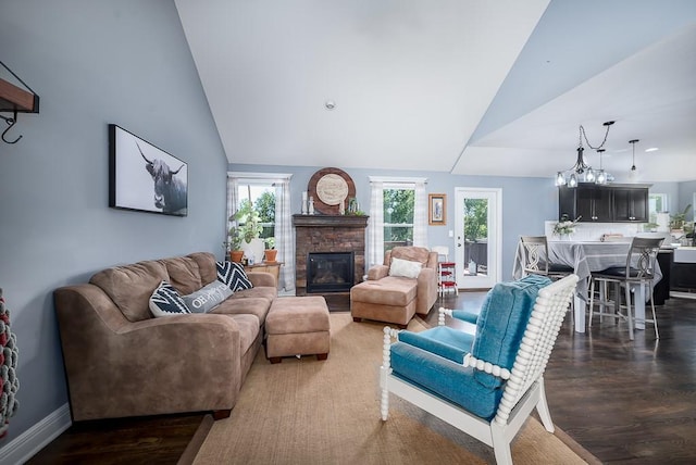 2251 Valley View Dr, Tonganoxie, KS 66086 - living area featuring vaulted ceiling, a fireplace, wood finished floors, and baseboards