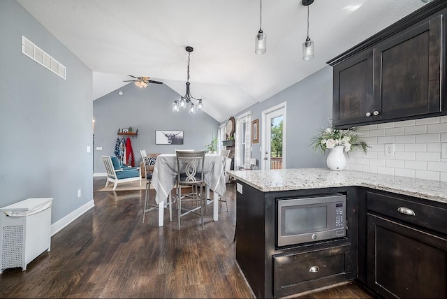 2251 Valley View Dr, Tonganoxie, KS 66086 - kitchen featuring stainless steel microwave, vaulted ceiling, dark wood-style flooring, tasteful backsplash, and ceiling fan