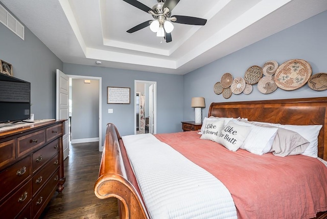 2251 Valley View Dr, Tonganoxie, KS 66086 - bedroom featuring dark wood finished floors, a raised ceiling, baseboards, ceiling fan, and ensuite bath