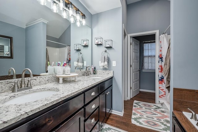 2251 Valley View Dr, Tonganoxie, KS 66086 - full bathroom with wood finished floors, a shower with curtain, double vanity, and baseboards
