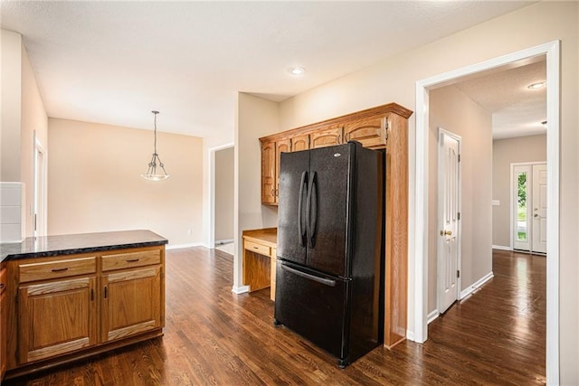 kitchen with freestanding refrigerator, dark wood-style floors, baseboards, brown cabinets, and recessed lighting