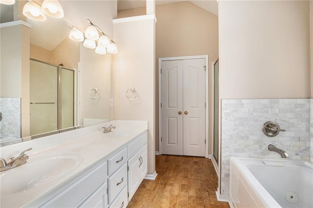 bathroom featuring a jetted tub, double vanity, a stall shower, and baseboards