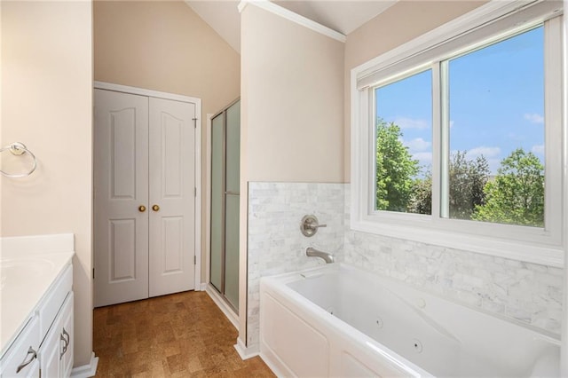 full bathroom with vanity, a shower stall, a jetted tub, tile patterned floors, and ornamental molding