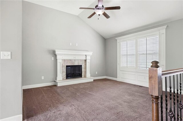 unfurnished living room with a ceiling fan, carpet, lofted ceiling, and a premium fireplace