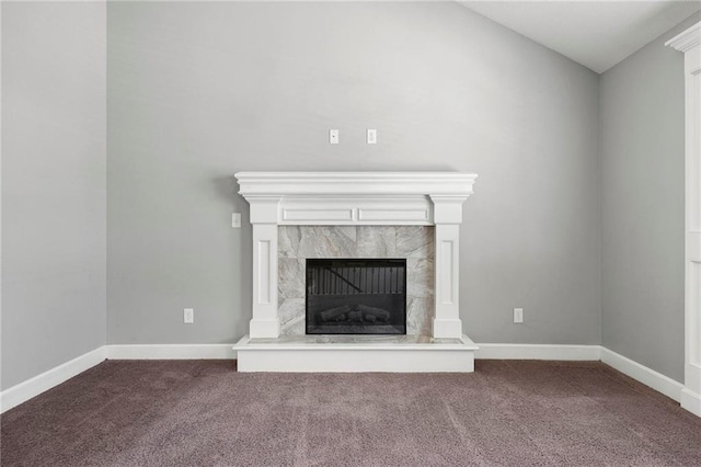 unfurnished living room with carpet floors, a fireplace, baseboards, and lofted ceiling