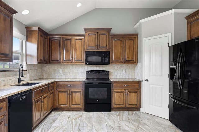 kitchen with black appliances, a sink, lofted ceiling, light marble finish flooring, and light stone countertops