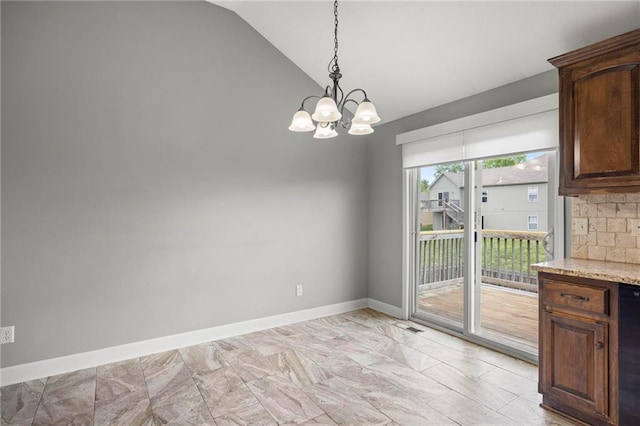 unfurnished dining area featuring vaulted ceiling, a chandelier, and baseboards
