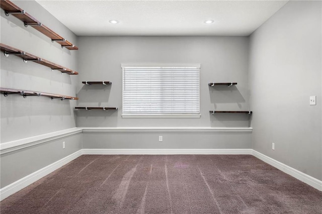 carpeted empty room featuring baseboards and recessed lighting