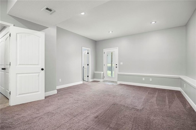carpeted empty room with baseboards and recessed lighting