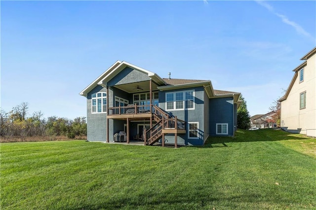 16609 Cody St, Overland Park, KS 66221 - rear view of house featuring a ceiling fan, stairs, a wooden deck, and a lawn