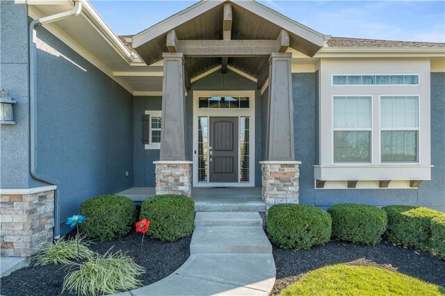 16609 Cody St, Overland Park, KS 66221 - view of exterior entry with stucco siding, stone siding, and covered porch