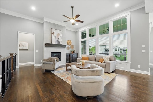 16609 Cody St, Overland Park, KS 66221 - living room featuring a ceiling fan, a fireplace, dark wood-style flooring, crown molding, and recessed lighting