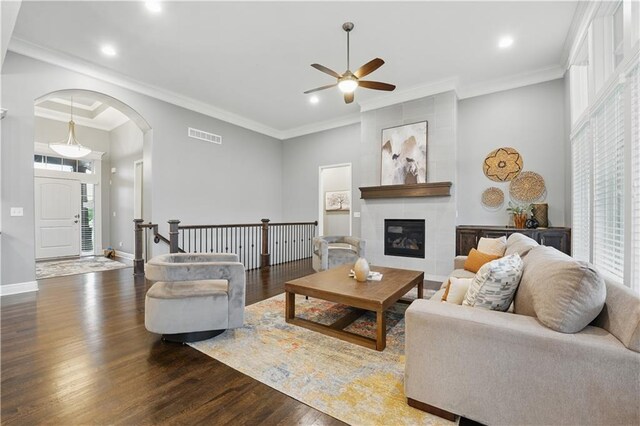 16609 Cody St, Overland Park, KS 66221 - living area with ceiling fan, arched walkways, wood finished floors, recessed lighting, and a tiled fireplace