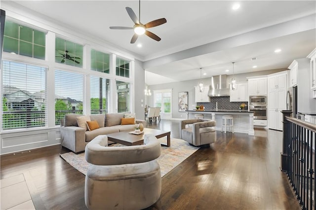 16609 Cody St, Overland Park, KS 66221 - living room featuring a ceiling fan, dark wood-style flooring, recessed lighting, ornamental molding, and a chandelier