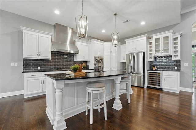 16609 Cody St, Overland Park, KS 66221 - kitchen with stainless steel refrigerator with ice dispenser, wall chimney range hood, beverage cooler, dark countertops, and tasteful backsplash