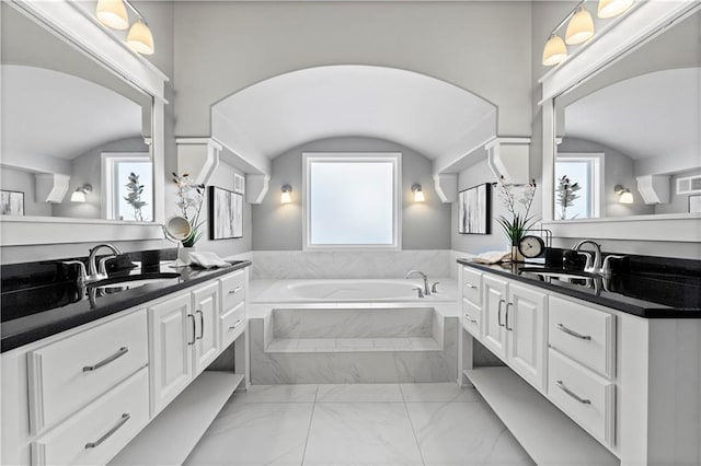 16609 Cody St, Overland Park, KS 66221 - bathroom featuring two vanities, a garden tub, and healthy amount of natural light
