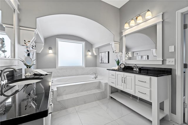16609 Cody St, Overland Park, KS 66221 - bathroom featuring marble look tiles, vanity, and a garden tub