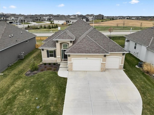 16521 S Stagecoach St, Olathe, KS 66062 - view of front of house with stucco siding, stone siding, and roof with shingles
