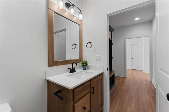 16521 S Stagecoach St, Olathe, KS 66062 - half bath with vanity, wood finished floors, and toilet