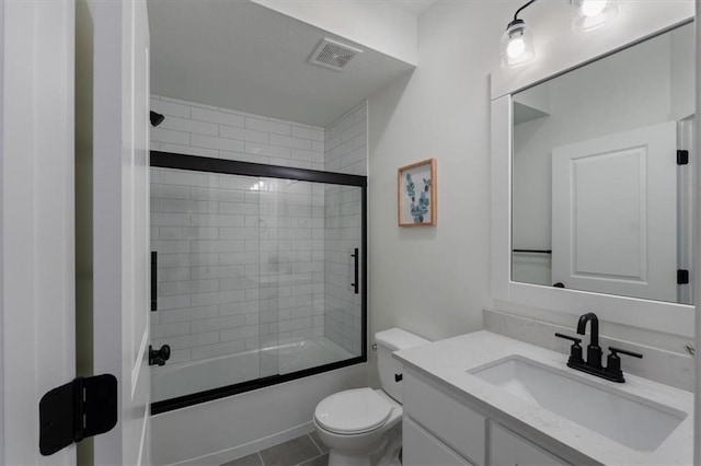 16521 S Stagecoach St, Olathe, KS 66062 - full bathroom with toilet, vanity, bath / shower combo with glass door, and tile patterned flooring
