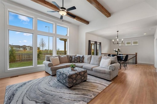 16521 S Stagecoach St, Olathe, KS 66062 - living area with a chandelier, light wood finished floors, beamed ceiling, and a ceiling fan