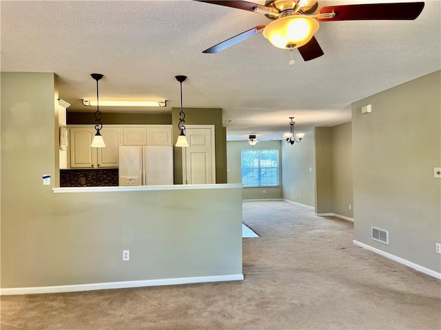 kitchen with white refrigerator with ice dispenser, light colored carpet, ceiling fan, hanging light fixtures, and baseboards