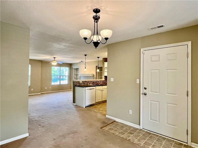 kitchen with dishwasher, baseboards, a ceiling fan, light carpet, and a textured ceiling