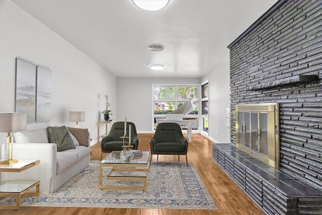 2647 Minnesota Ave, Kansas City, KS 66102 - living room featuring a fireplace, wood finished floors, and baseboards