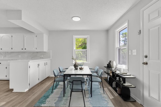2647 Minnesota Ave, Kansas City, KS 66102 - dining space with a textured ceiling, light wood finished floors, and baseboards