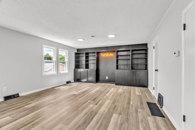2647 Minnesota Ave, Kansas City, KS 66102 - unfurnished bedroom with a textured ceiling, light wood finished floors, baseboards, and recessed lighting