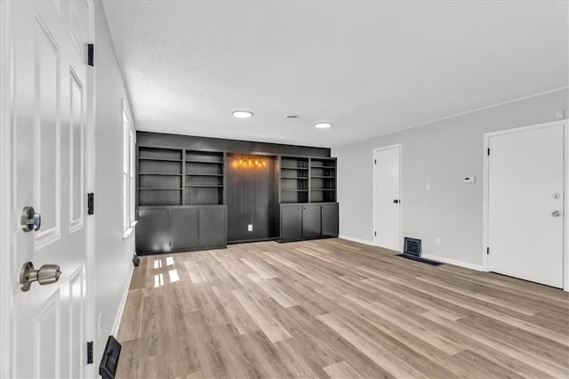 2647 Minnesota Ave, Kansas City, KS 66102 - unfurnished bedroom with light wood finished floors, baseboards, and recessed lighting