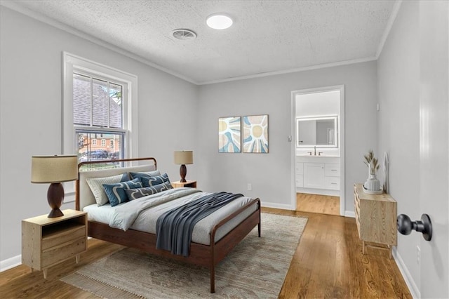 2647 Minnesota Ave, Kansas City, KS 66102 - bedroom featuring a textured ceiling, wood finished floors, baseboards, a sink, and crown molding
