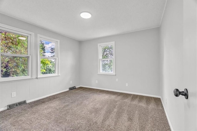 2647 Minnesota Ave, Kansas City, KS 66102 - unfurnished room featuring carpet floors, a textured ceiling, and baseboards