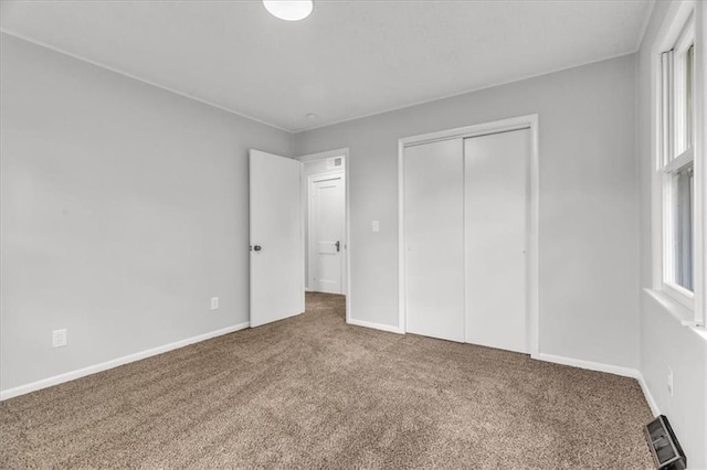 2647 Minnesota Ave, Kansas City, KS 66102 - unfurnished bedroom with carpet floors, a closet, and baseboards