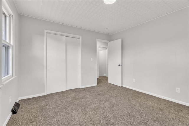 2647 Minnesota Ave, Kansas City, KS 66102 - unfurnished bedroom featuring carpet, a closet, and baseboards