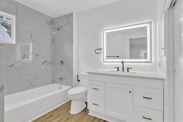 2647 Minnesota Ave, Kansas City, KS 66102 - bathroom with toilet, wood finished floors, vanity, and washtub / shower combination