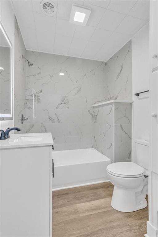 2647 Minnesota Ave, Kansas City, KS 66102 - bathroom featuring wood finished floors, toilet, and vanity