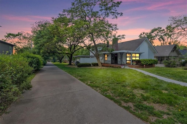 2647 Minnesota Ave, Kansas City, KS 66102 - view of front of home with a front yard, a chimney, and covered porch