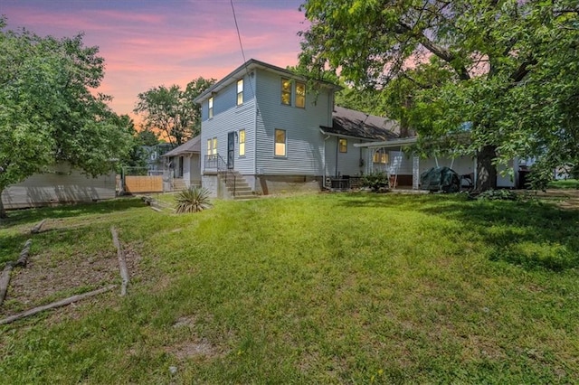 2647 Minnesota Ave, Kansas City, KS 66102 - back of house at dusk with a lawn