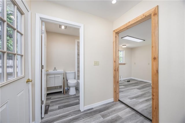 901 N 9th St, Neodesha, KS 66757 - bathroom featuring wood finished floors, toilet, vanity, and baseboards