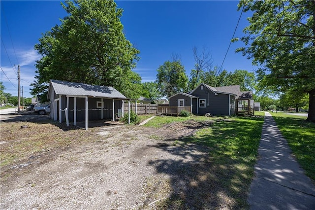 901 N 9th St, Neodesha, KS 66757 - view of side of property featuring a wooden deck and a yard