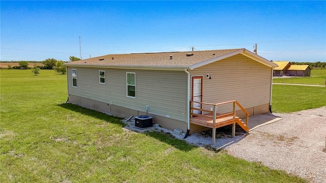 1365 NW 460th Rd, Holden, MO 64040 - back of house with a yard, central air condition unit, and a shingled roof