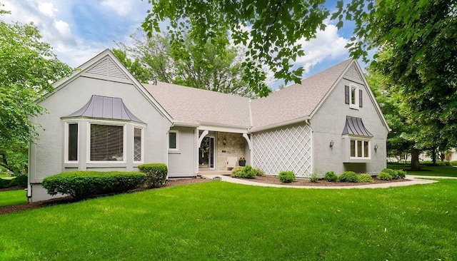 12808 Howe Dr, Leawood, KS 66209 - view of front of house with stucco siding, a front yard, a standing seam roof, and metal roof
